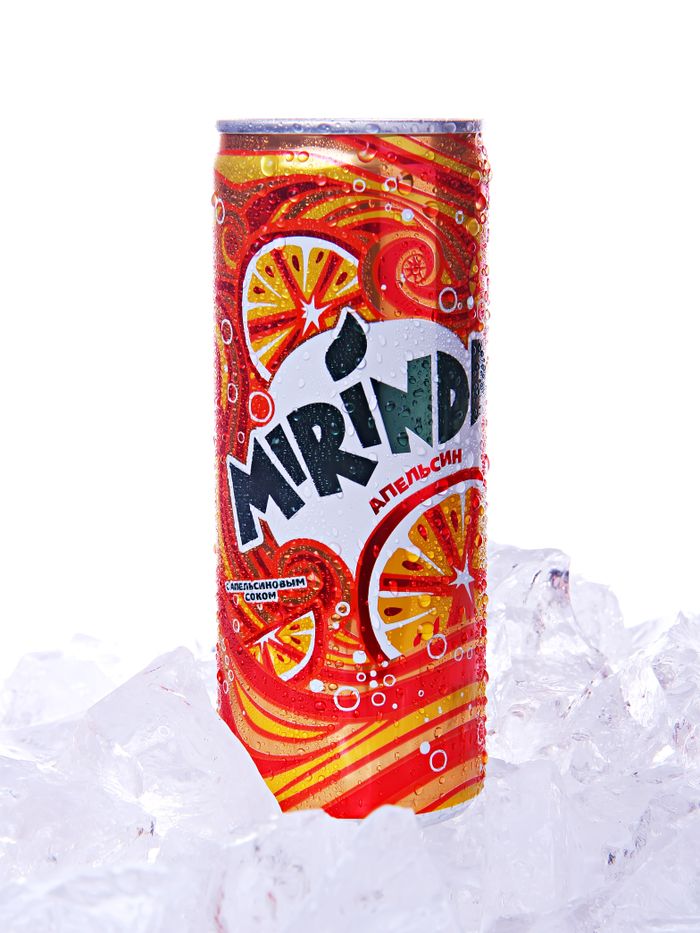 about-img Vibrant Mirinda soda can in close-up, chilled on ice for a refreshing look.
