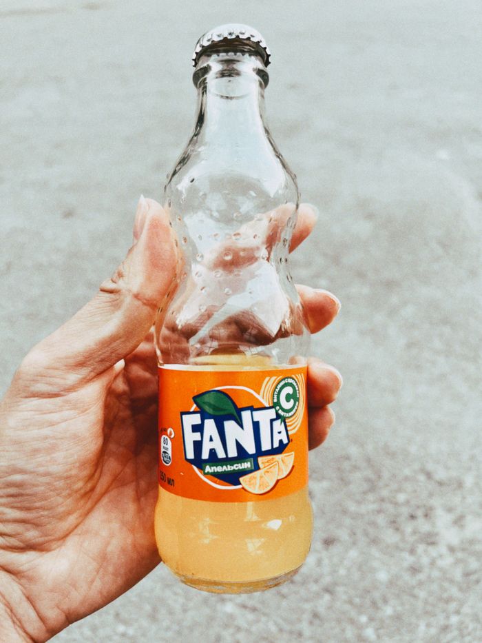 services-01 Close-up of a hand holding a Fanta bottle outdoors in Talgar, Kazakhstan.