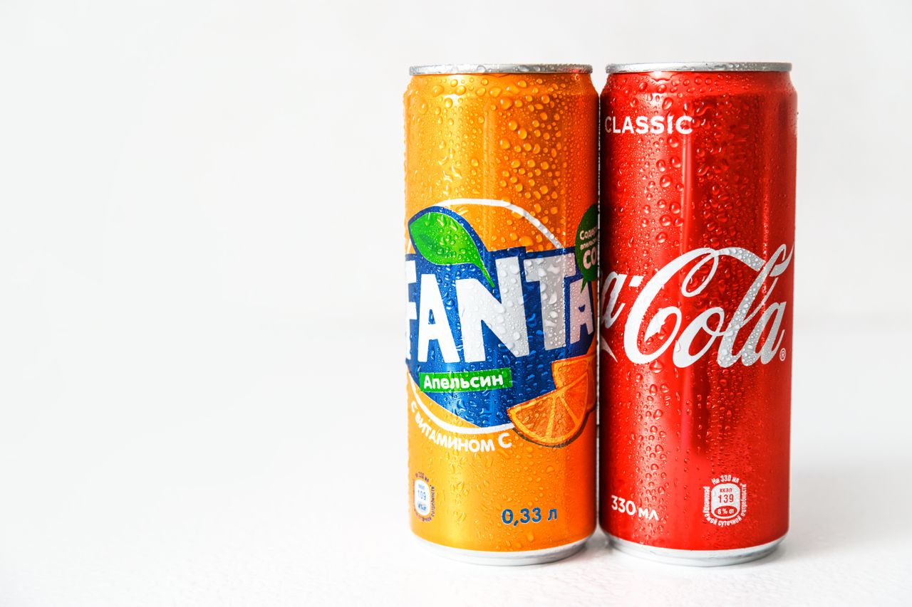 services-03 Close-up image of refreshing Coca-Cola and Fanta cans with water droplets.